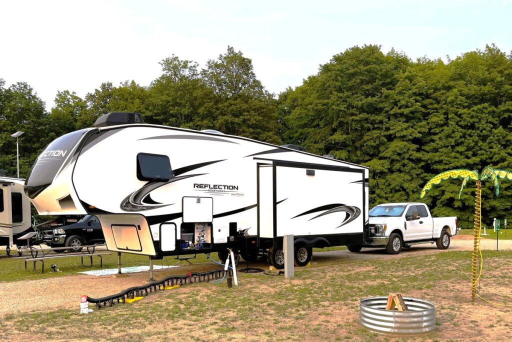 Image of Starlight RV Resort Campsite 131 with truck and travel trailer